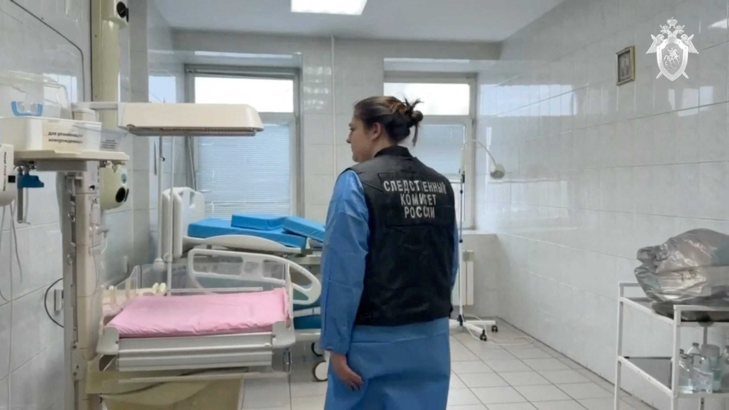 An investigator inspects a delivery room in a maternity hospital in Novokuzhetsk
