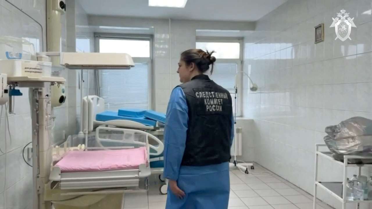 An investigator inspects a delivery room in a maternity hospital in Novokuzhetsk