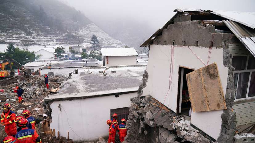 Rescue workers search for survivors near damaged houses after a landslide hit Zhenxiong county in Zhaotong