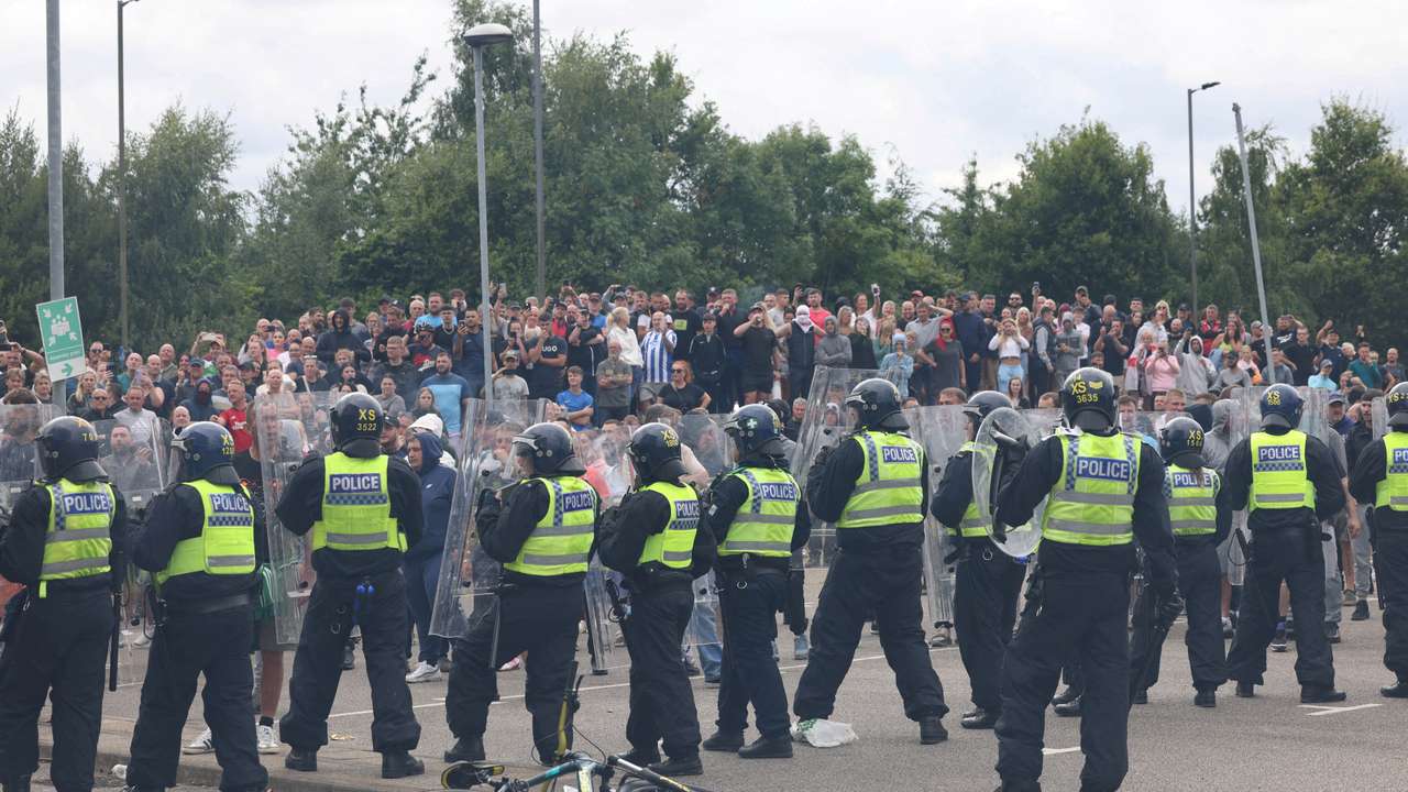 FILE PHOTO: Police officers stand guard during an anti-immigration protest, in Rotherham