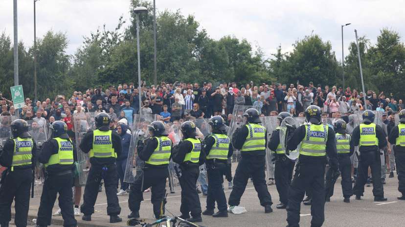 FILE PHOTO: Police officers stand guard during an anti-immigration protest, in Rotherham