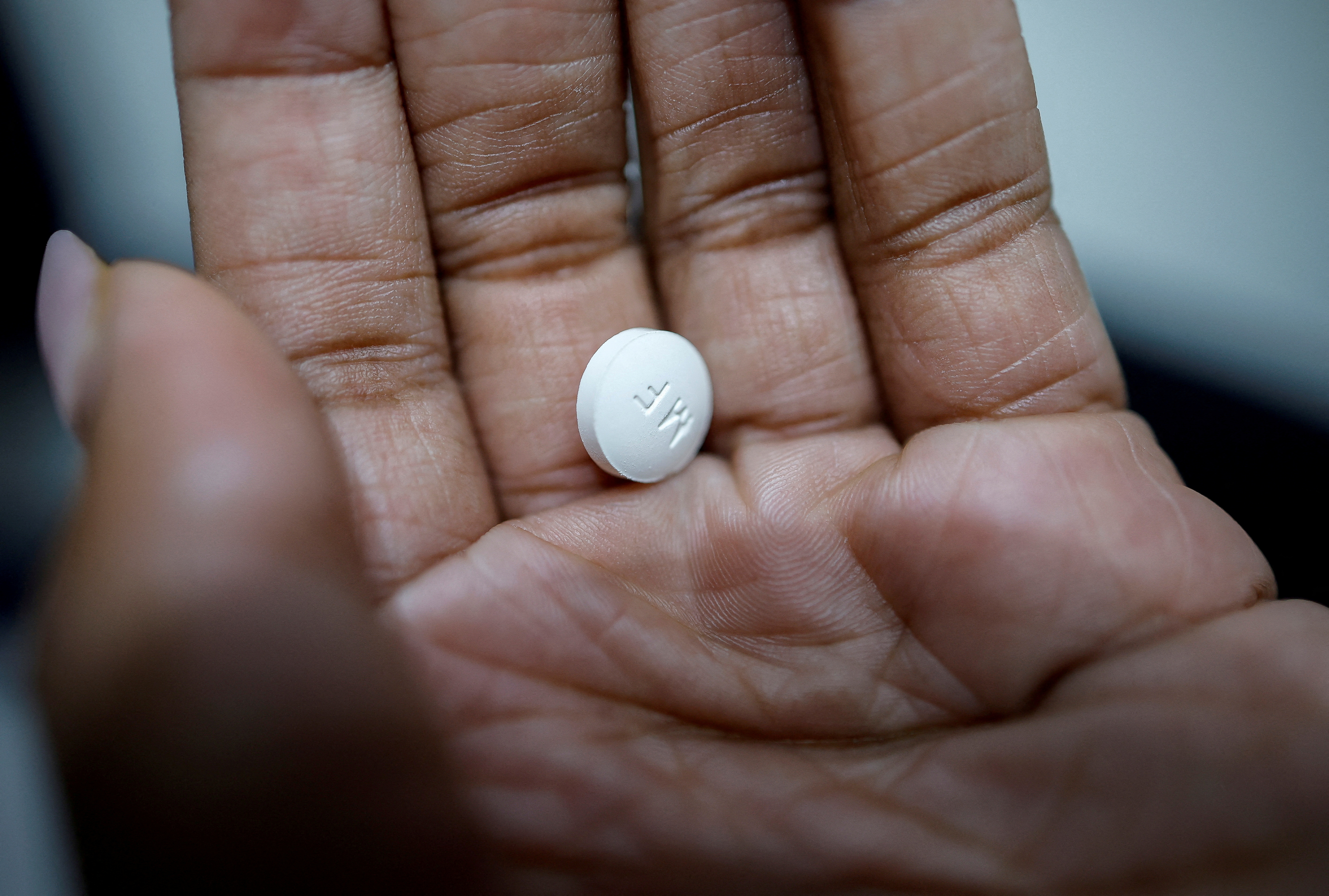 FILE PHOTO: A patient prepares to take Mifepristone, the first medication in a medical abortion, at Alamo Women's Clinic in Carbondale