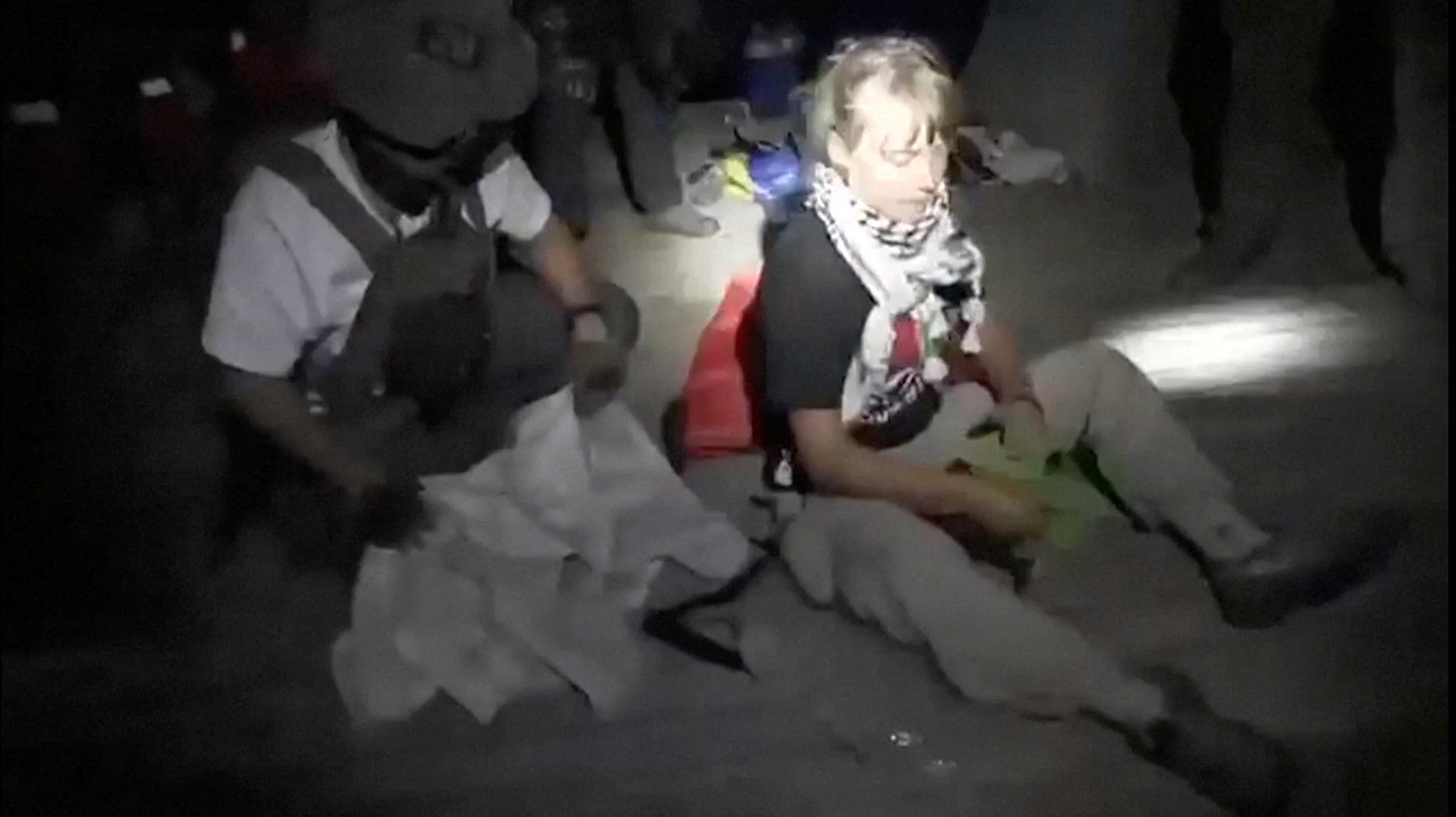Swedish activist Greta Thunberg sitting next to a person wearing military gear, as vessels of the Global Sumud Flotilla are being intercepted by Israeli security forces