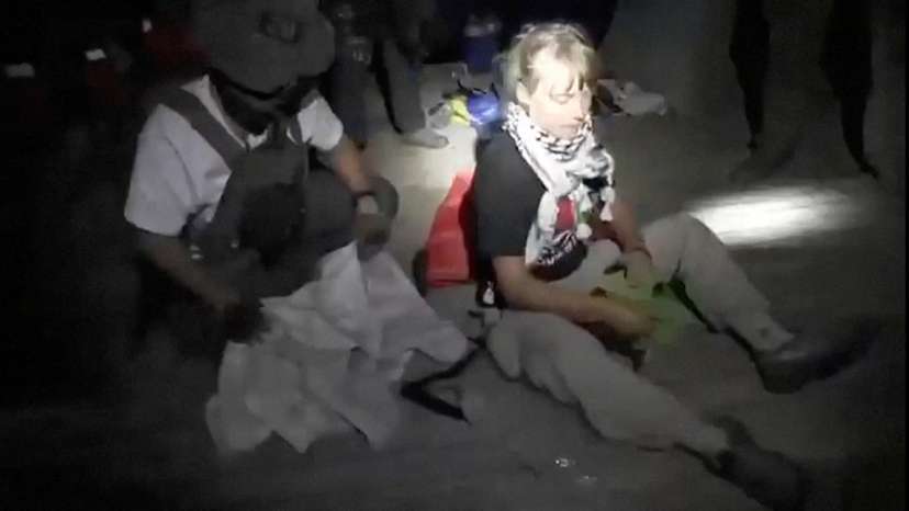Swedish activist Greta Thunberg sitting next to a person wearing military gear, as vessels of the Global Sumud Flotilla are being intercepted by Israeli security forces