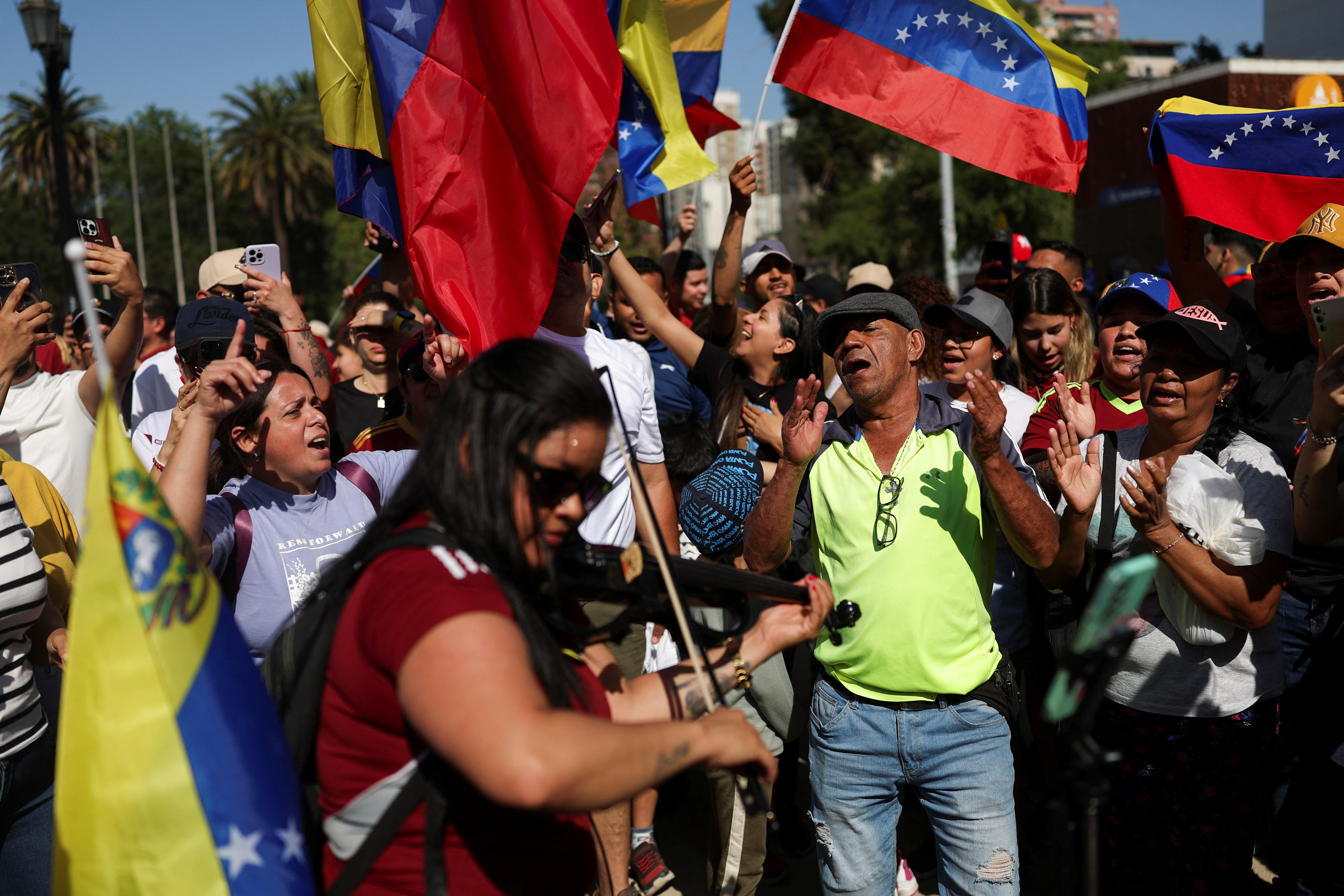 People react to the news of U.S. strikes on Venezuela and capture of President Maduro, in Santiago