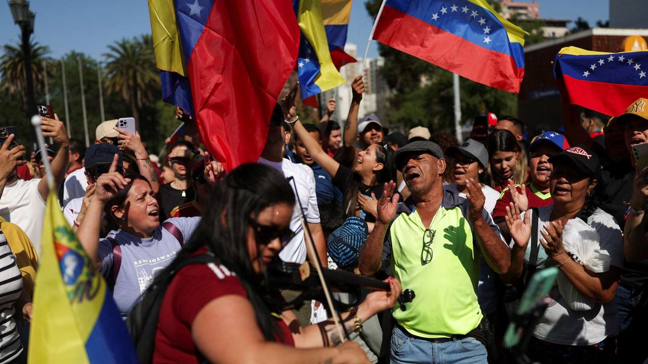 People react to the news of U.S. strikes on Venezuela and capture of President Maduro, in Santiago