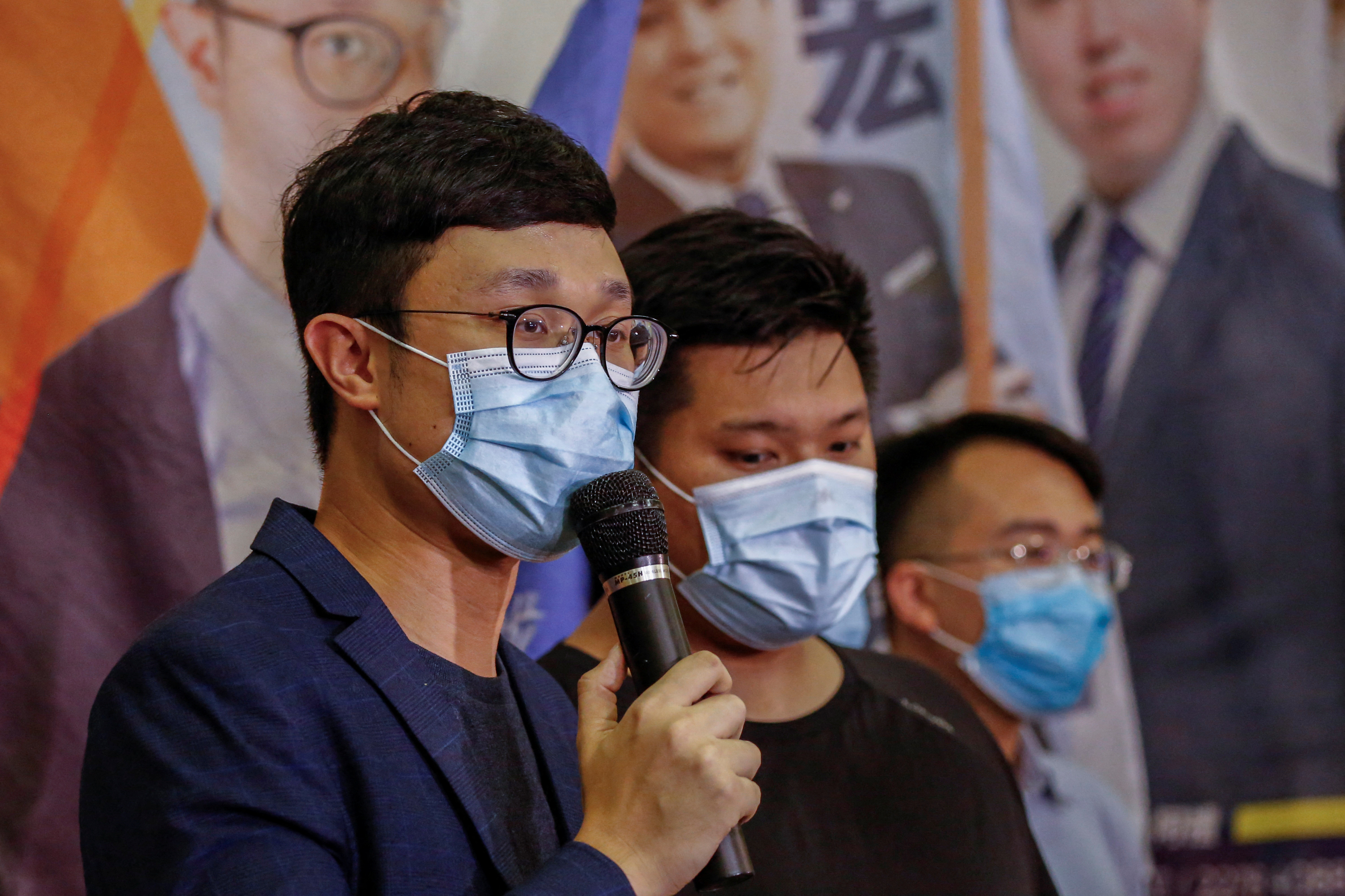 Political activist Ventus Lau Wing-hong speaks to the media after he was disqualified from running for election for the legislature in Hong Kong