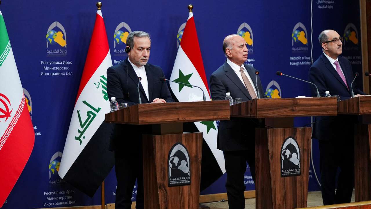 Iraqi Foreign Minister Fuad Hussein speaks during a news conference as Syrian foreign minister Bassam Sabbagh and Iranian Foreign Minister Abbas Araghchi stand, in Baghdad
