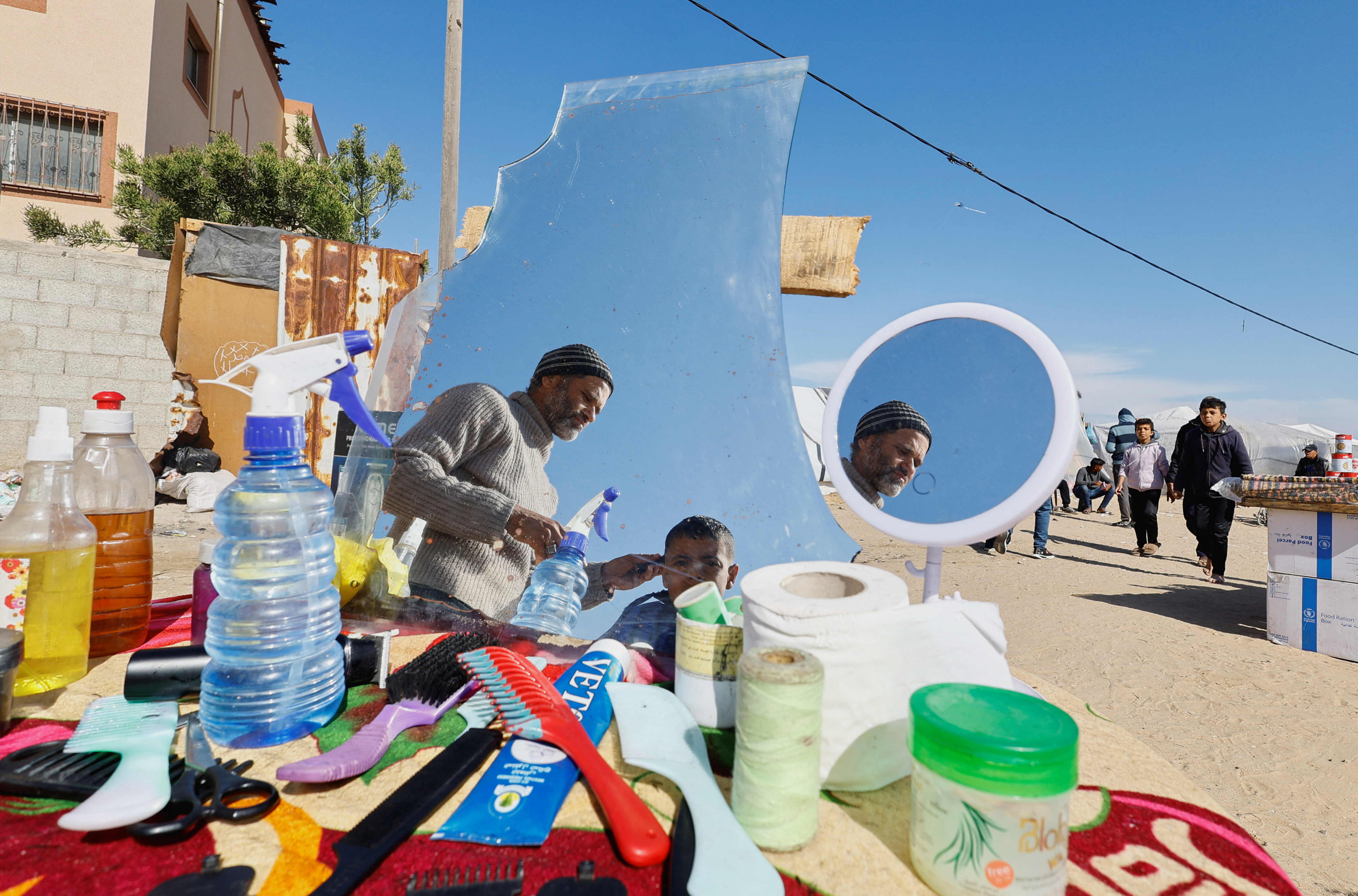 Displaced Palestinian, who fled their houses due to Israeli strikes, take shelter in a tent camp in Rafah
