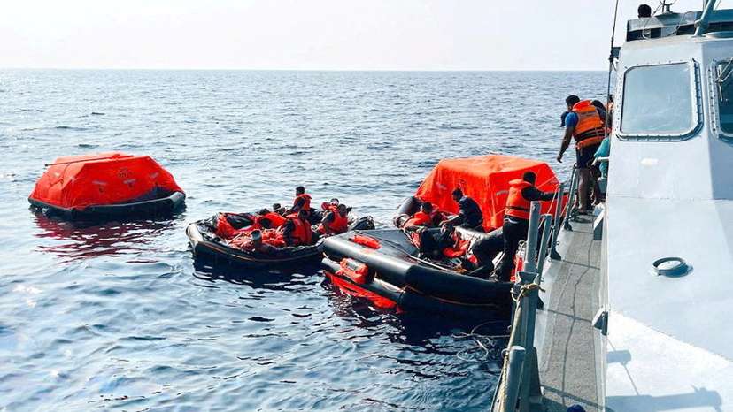 Sri Lanka Navy personnel assist Iranian sailors during a rescue operation in Indian Ocean