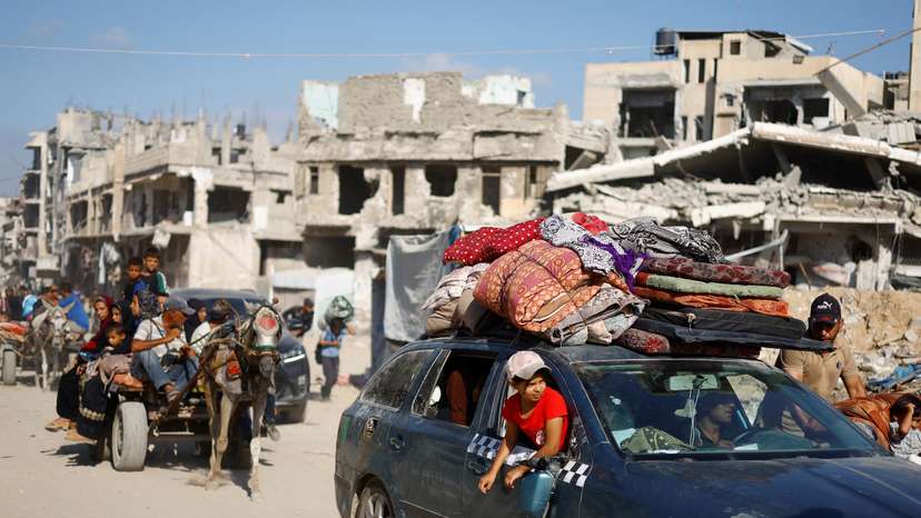 Palestinians make their way to return to neighbourhoods after Israeli forces pulled out from the eastern side of Khan Younis, in Khan Younis, in the southern Gaza Strip
