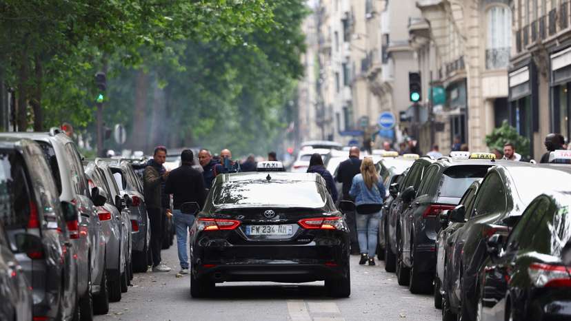 French taxi drivers gather for a strike protesting over proposed government cuts to cash for ferrying patients to and from medical appointments, in Paris