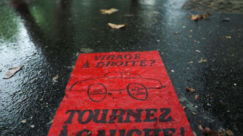 A flyer reading "Right turn? Turn left!" lies on the pavement prior to the second round of the early French parliamentary elections