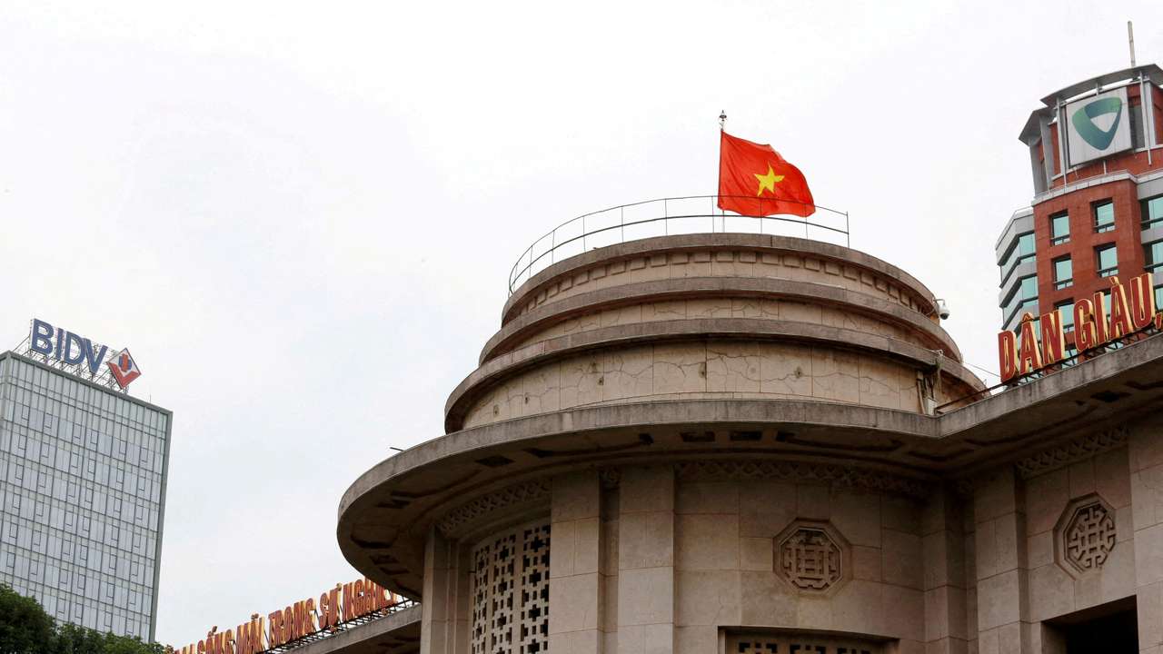 FILE PHOTO: A Vietnamese flag flies atop the State Bank building in central Hanoi