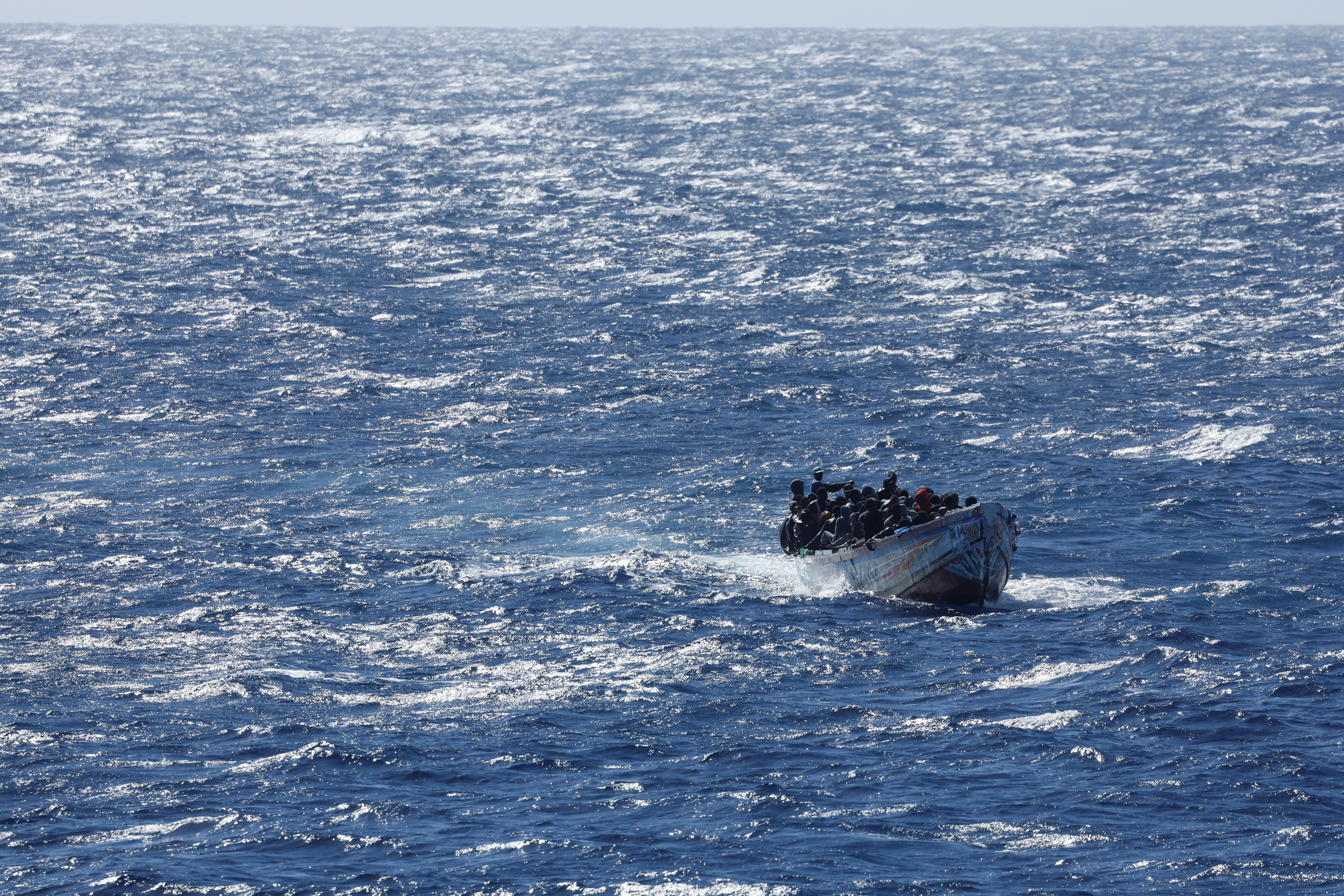 Migrants arrive on a wooden boat near the port of La Restinga on the Canary Island of El Hierro