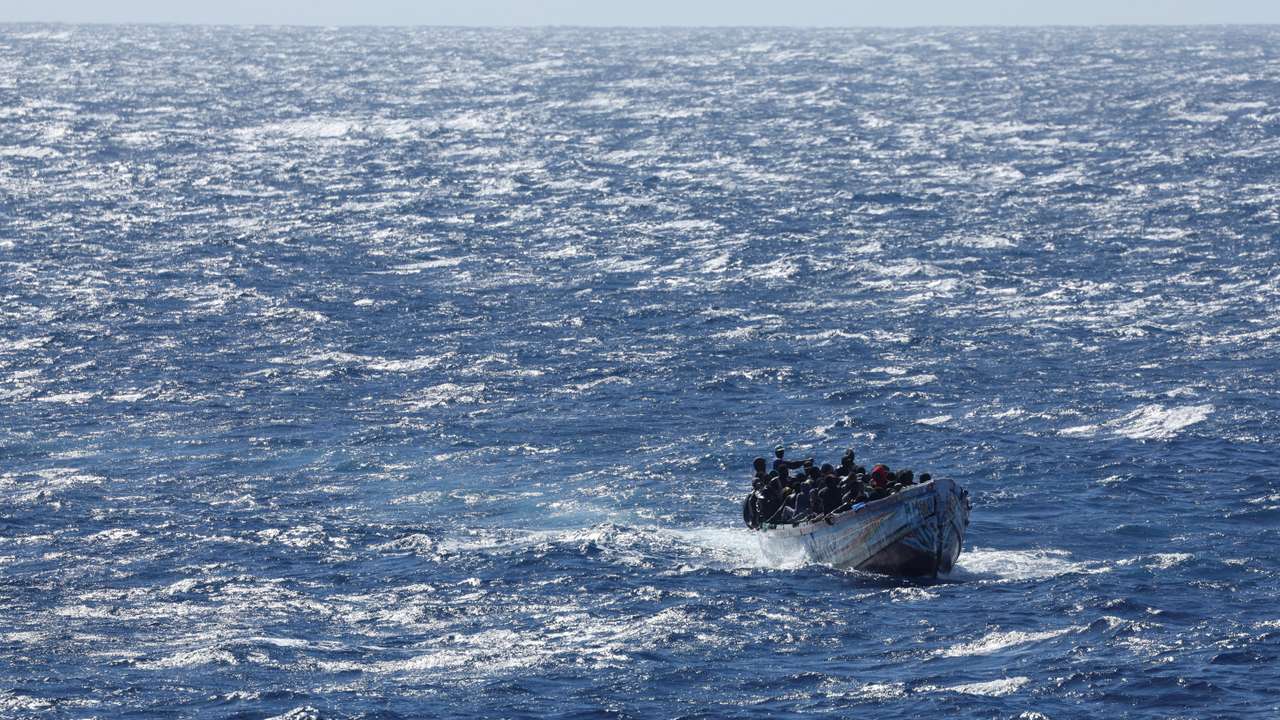 Migrants arrive on a wooden boat near the port of La Restinga on the Canary Island of El Hierro