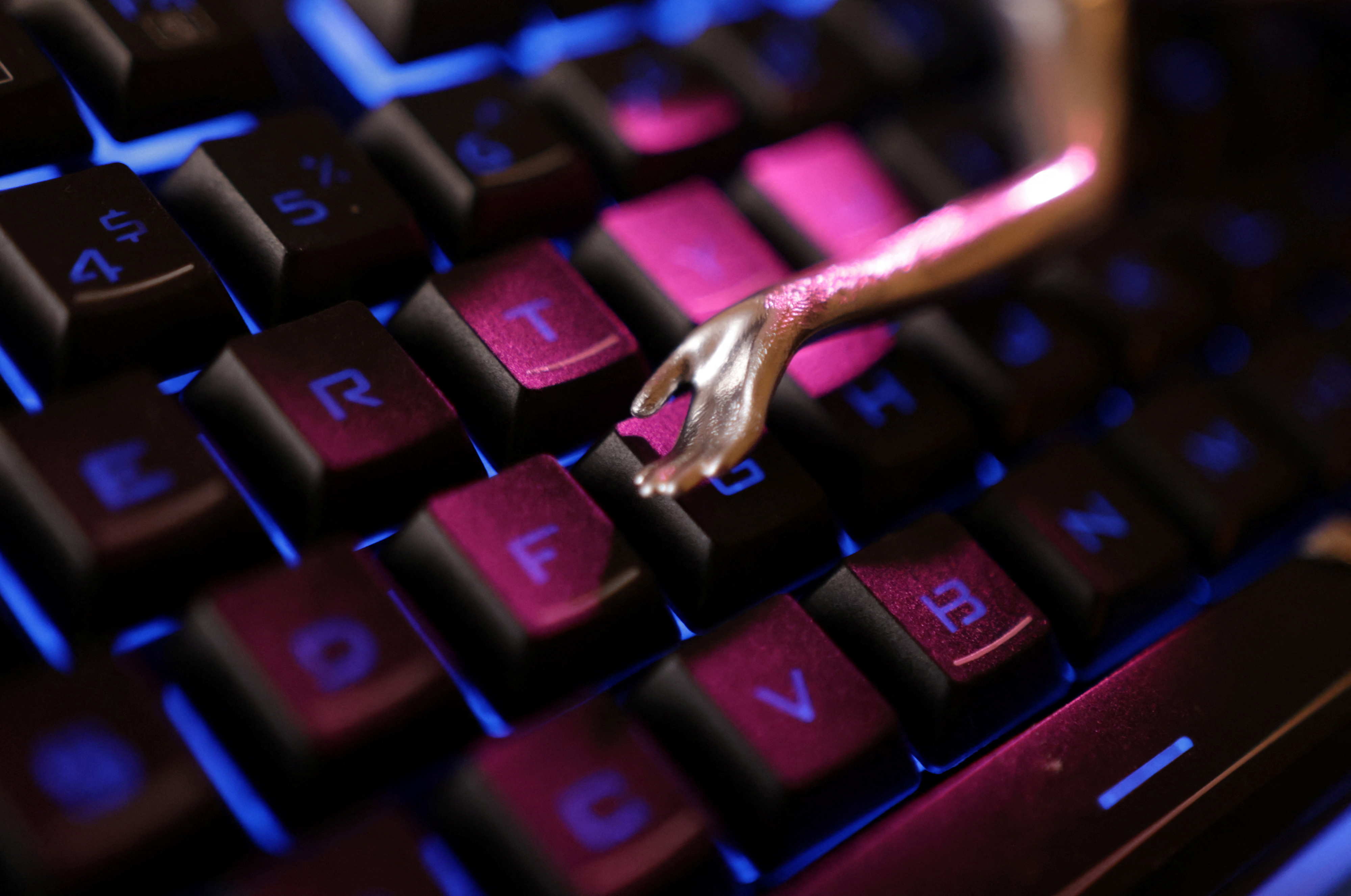 Keyboard and a miniature hand are seen in this illustration