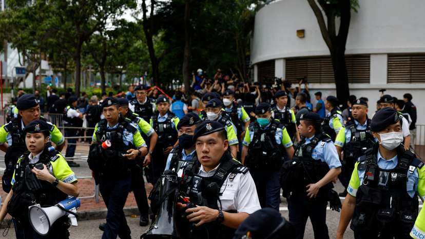 Police stand guard outside the West Kowloon Magistrates' Courts building during the verdict of the 47 pro-democracy activists charged under the national security law, in Hong Kong