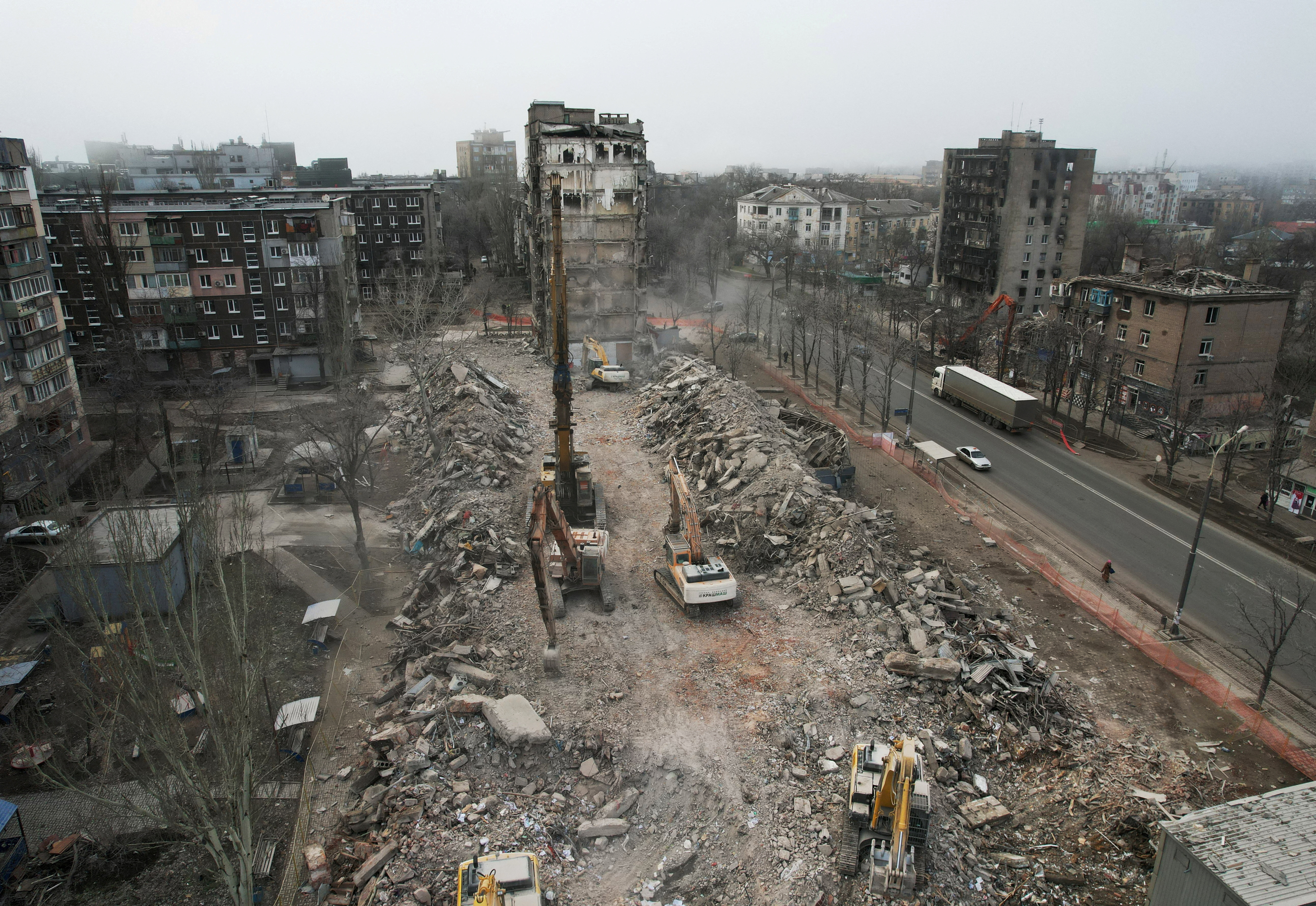 FILE PHOTO: Workers demolish a building, which was destroyed in the course of Russia-Ukraine conflict, in Mariupol