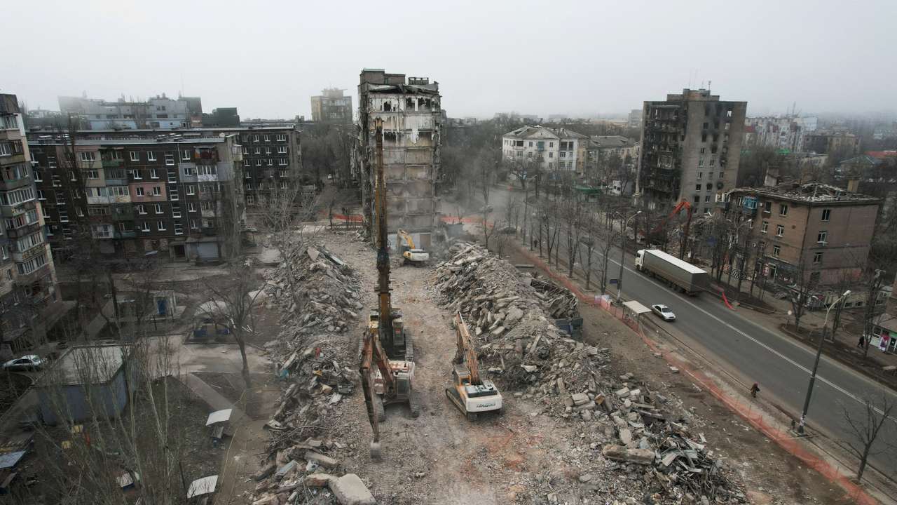 FILE PHOTO: Workers demolish a building, which was destroyed in the course of Russia-Ukraine conflict, in Mariupol