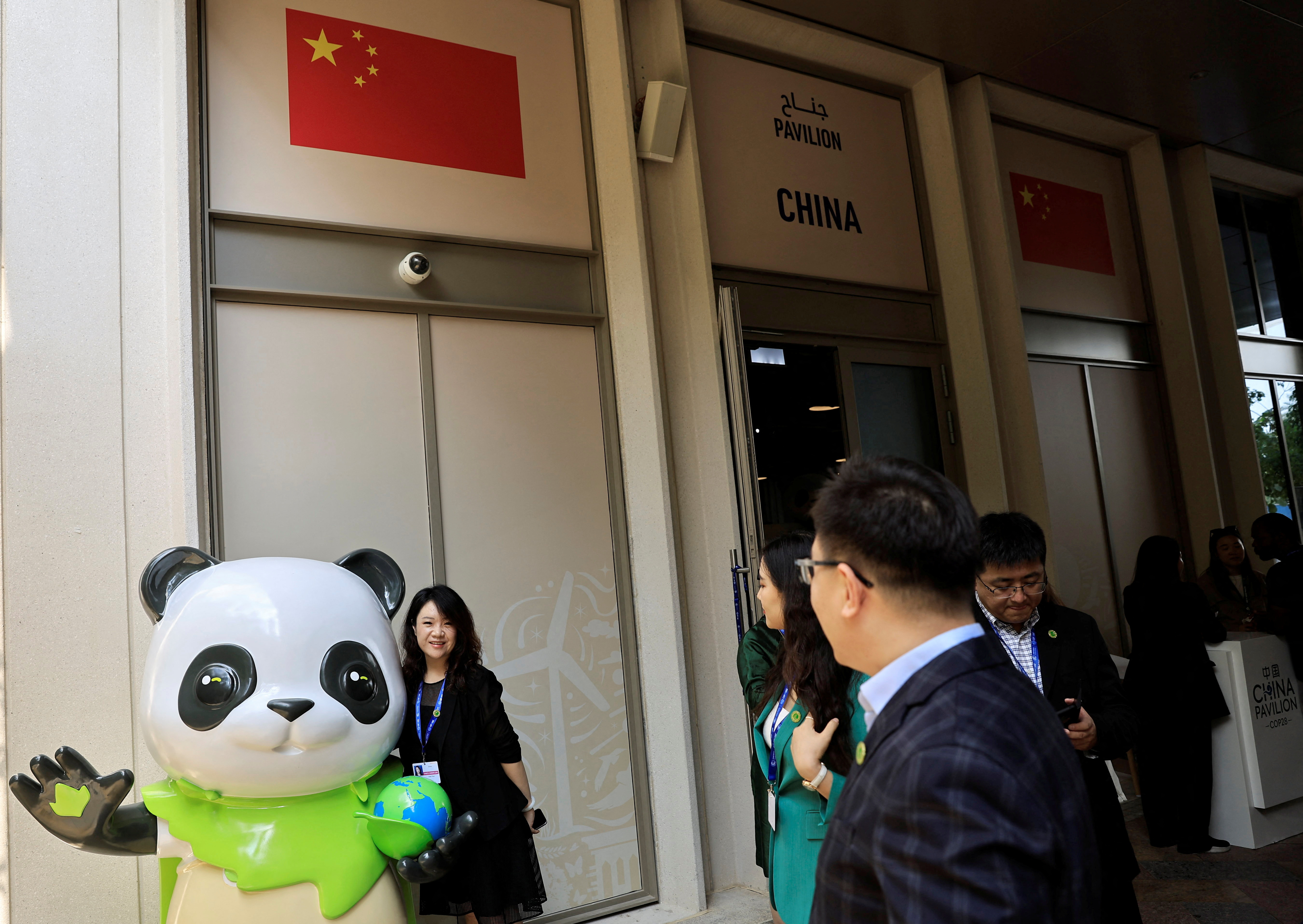 People stand near the China Pavilion at the United Nations Climate Change Conference COP28 in Dubai