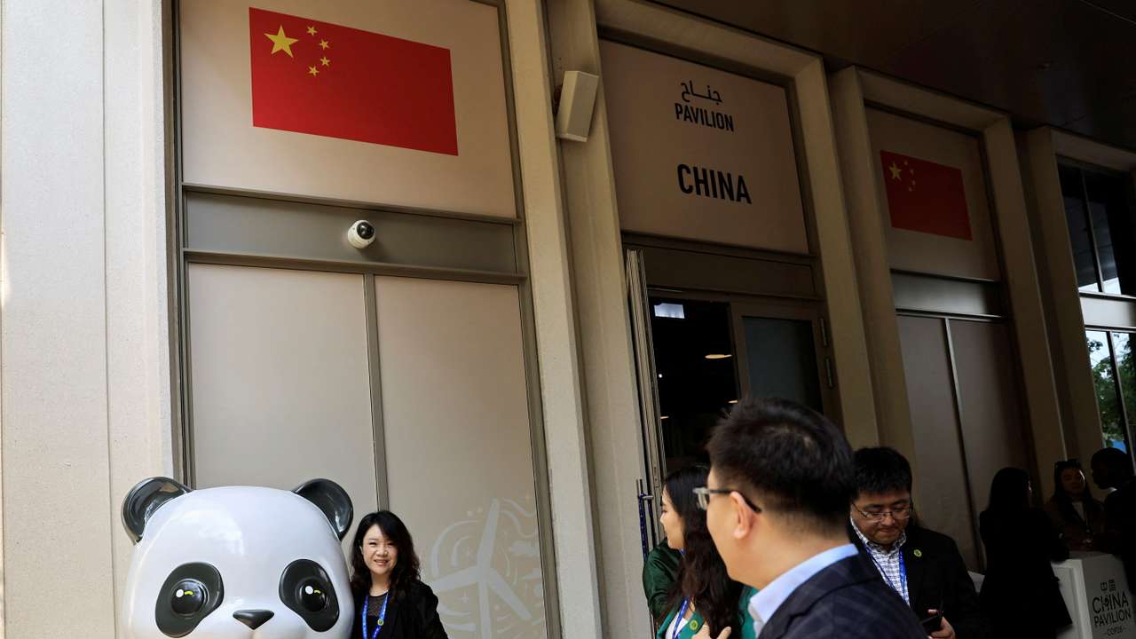 People stand near the China Pavilion at the United Nations Climate Change Conference COP28 in Dubai