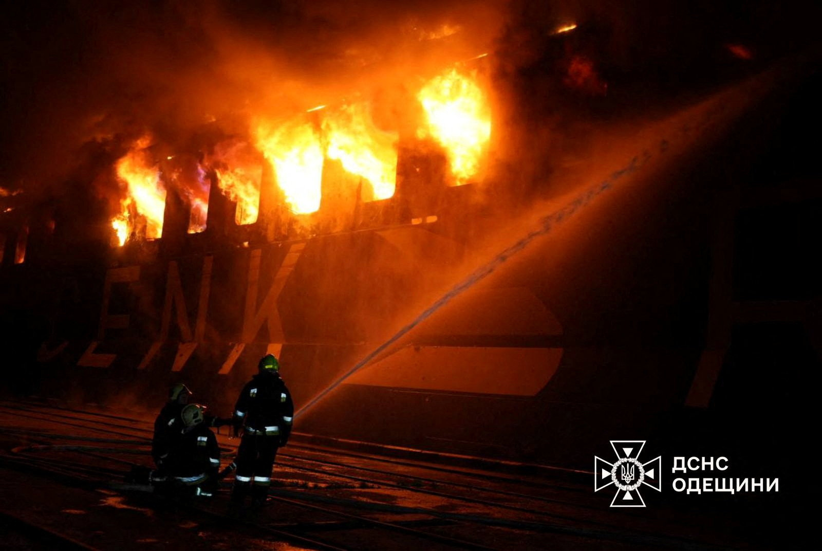Firefighters work at the site of a civilian vessel hit during a Russian missile strike in the town of Chornomorsk