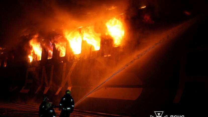 Firefighters work at the site of a civilian vessel hit during a Russian missile strike in the town of Chornomorsk