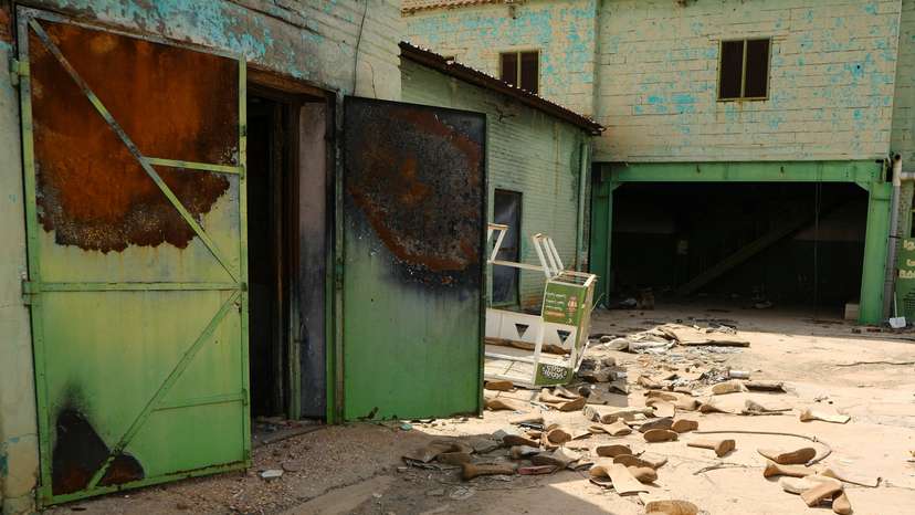 Safety shoes are scattered in a destroyed factory in Omdurman