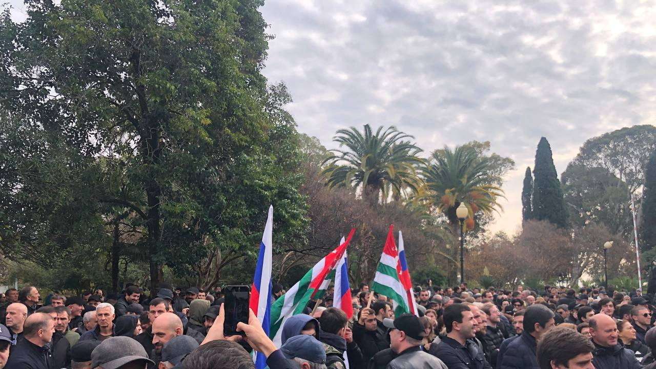 FILE PHOTO: Protesters rally outside the parliament building in the capital of Georgia's breakaway region of Abkhazia