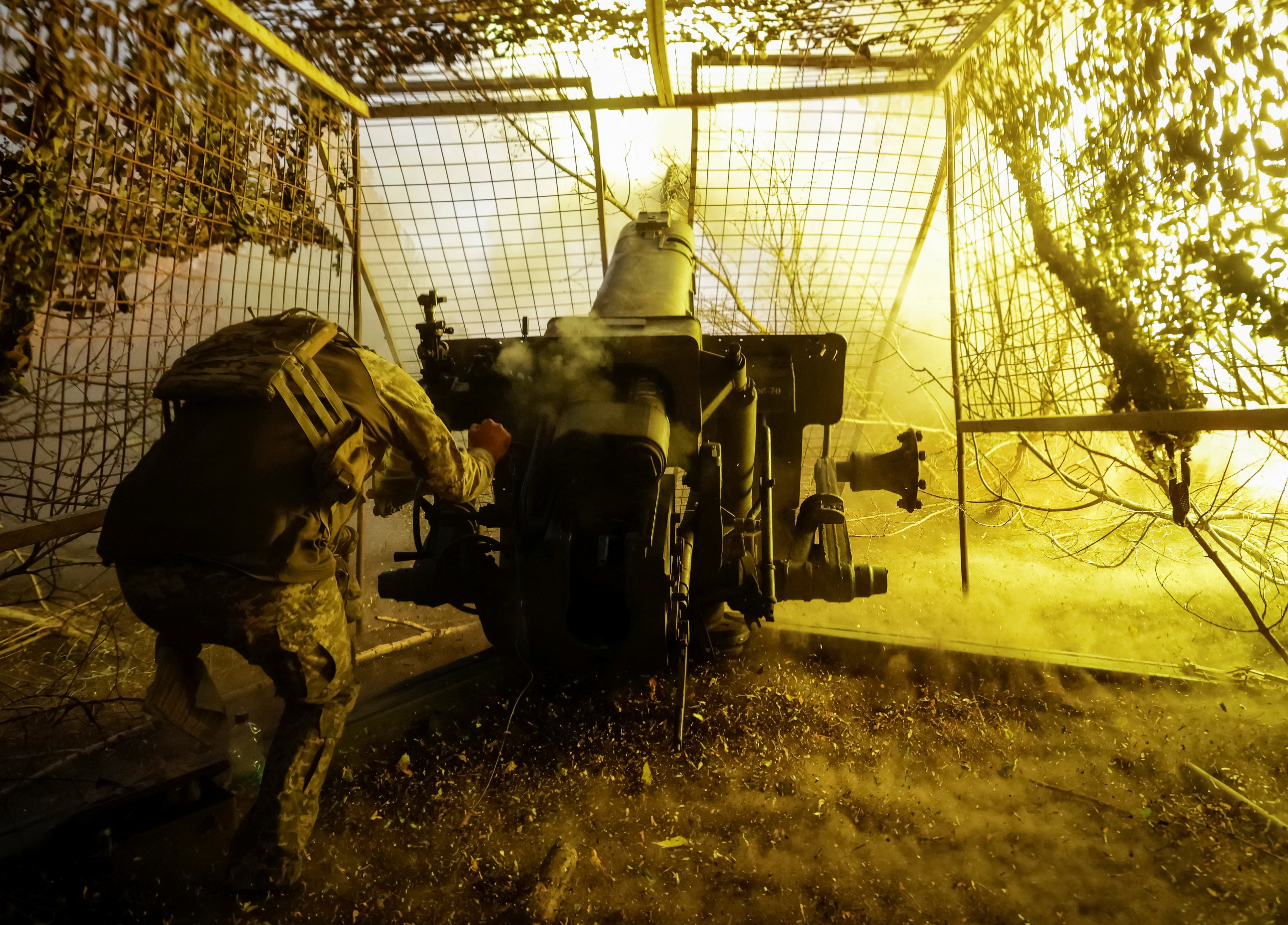 Ukrainian serviceman fires a D-30 howitzer towards Russian troops near the front line town of Kupiansk