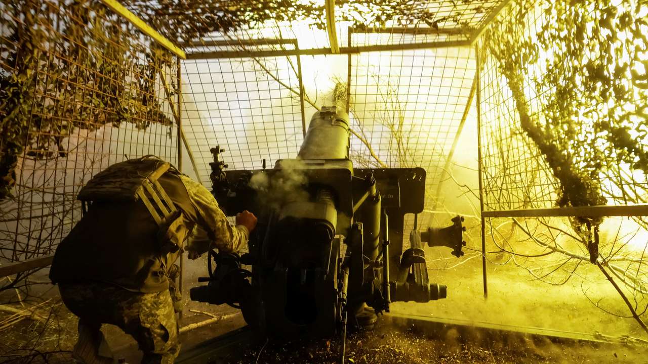 Ukrainian serviceman fires a D-30 howitzer towards Russian troops near the front line town of Kupiansk
