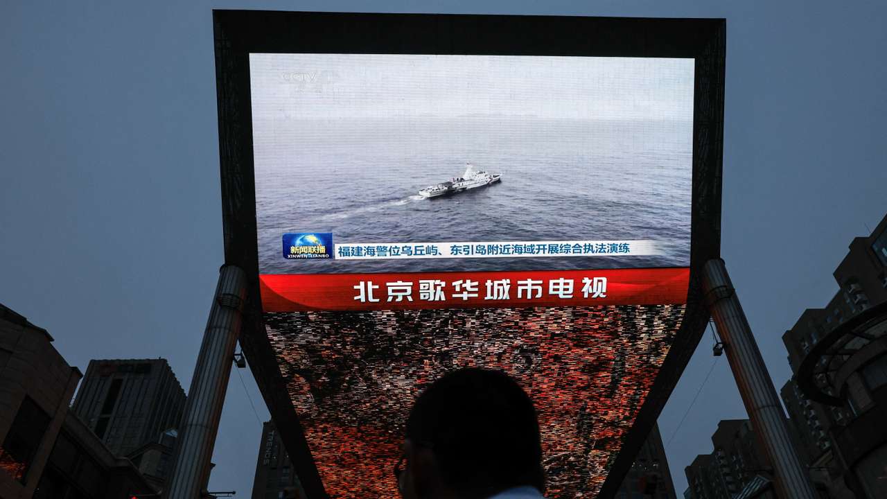 Screen shows news footage of military drills conducted in areas around the island of Taiwan by the Eastern Theatre Command of the Chinese People's Liberation Army (PLA), in Beijing