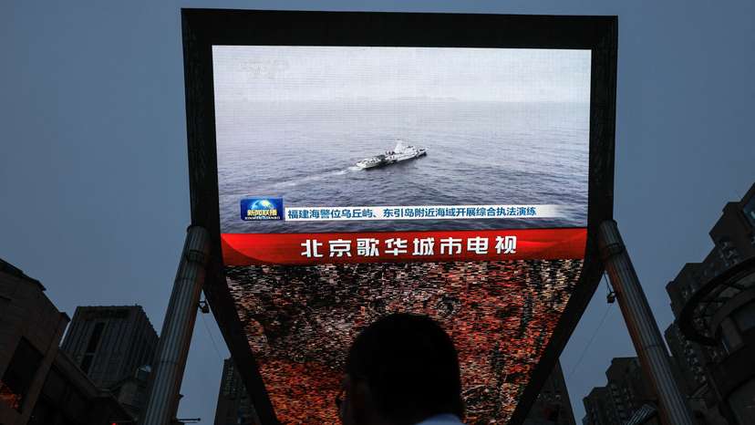 Screen shows news footage of military drills conducted in areas around the island of Taiwan by the Eastern Theatre Command of the Chinese People's Liberation Army (PLA), in Beijing