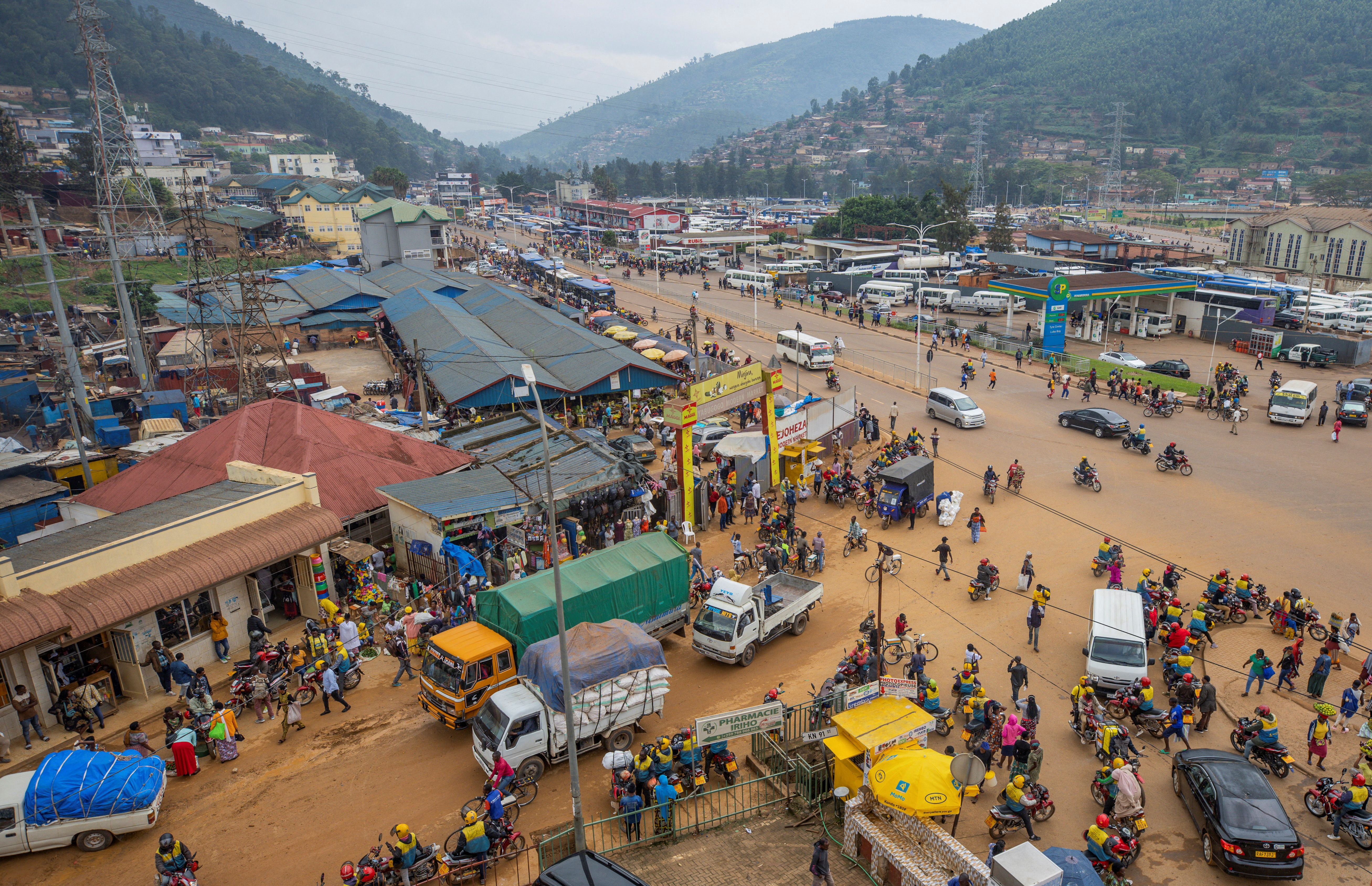 Motorists move along a street in the outskirts Kigali