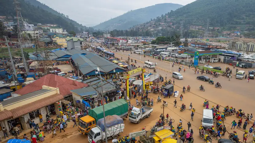Motorists move along a street in the outskirts Kigali
