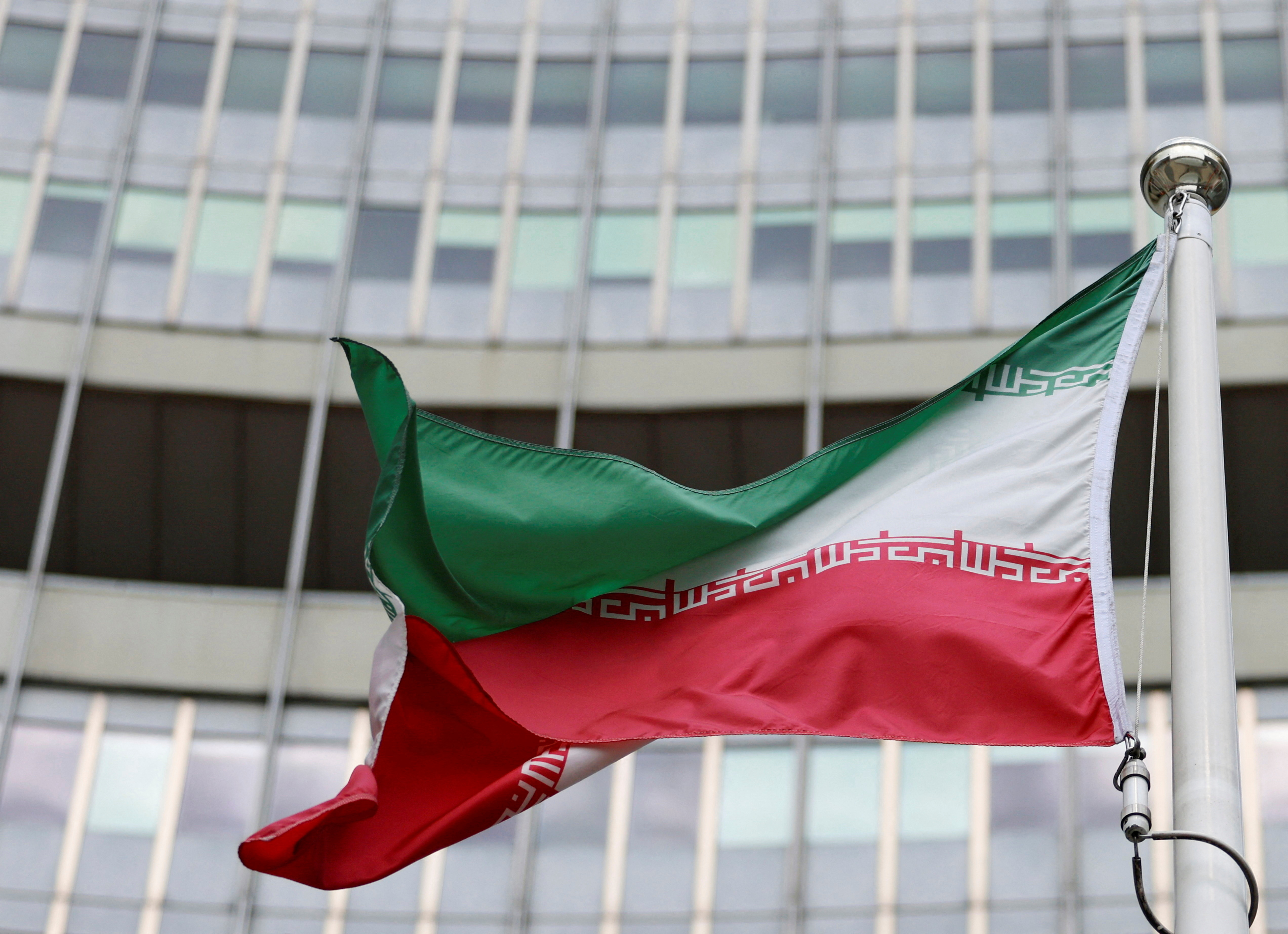 The Iranian flag flutters outside the IAEA headquarters in Vienna