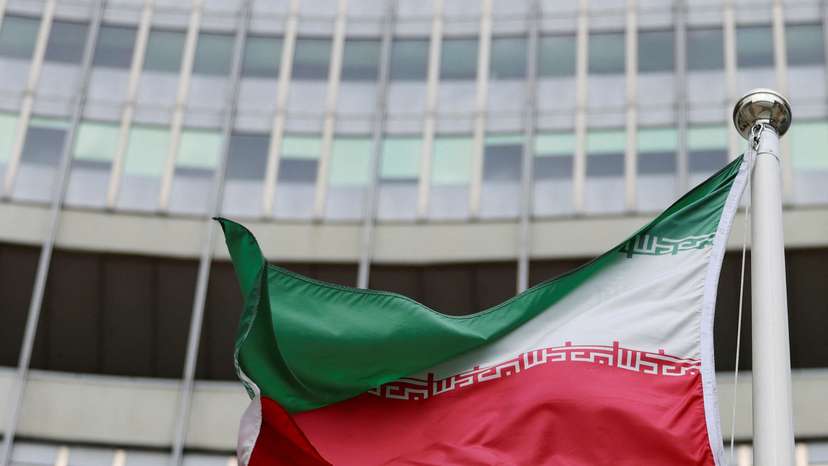 The Iranian flag flutters outside the IAEA headquarters in Vienna