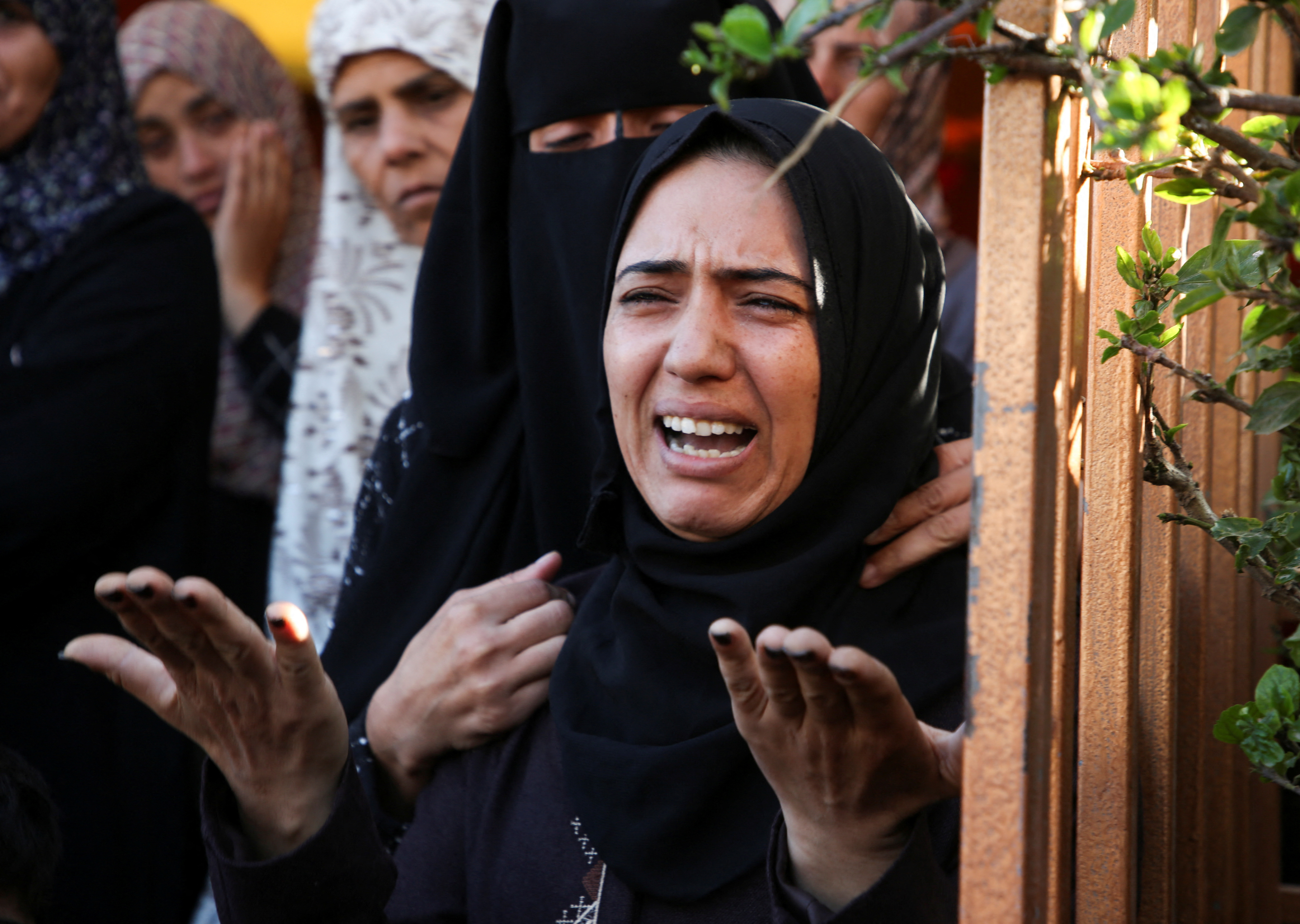 Palestinians mourn loved ones killed in Israeli strikes, in Khan Younis in the southern Gaza Strip