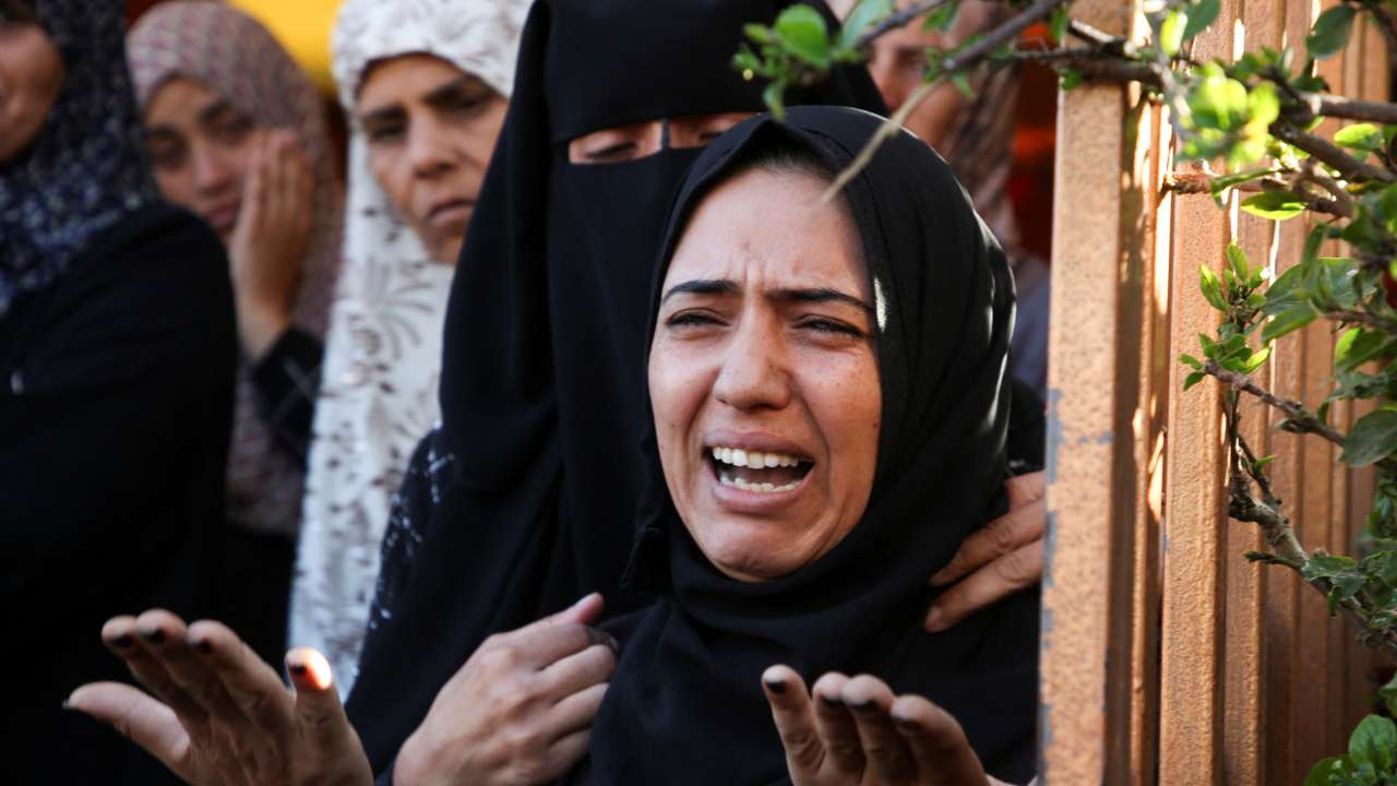 Palestinians mourn loved ones killed in Israeli strikes, in Khan Younis in the southern Gaza Strip
