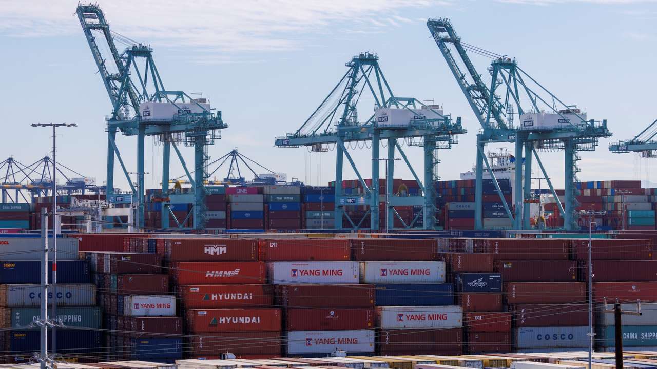 Stacked containers and crains are shown at the Port of Los Angeles in Los Angeles, California