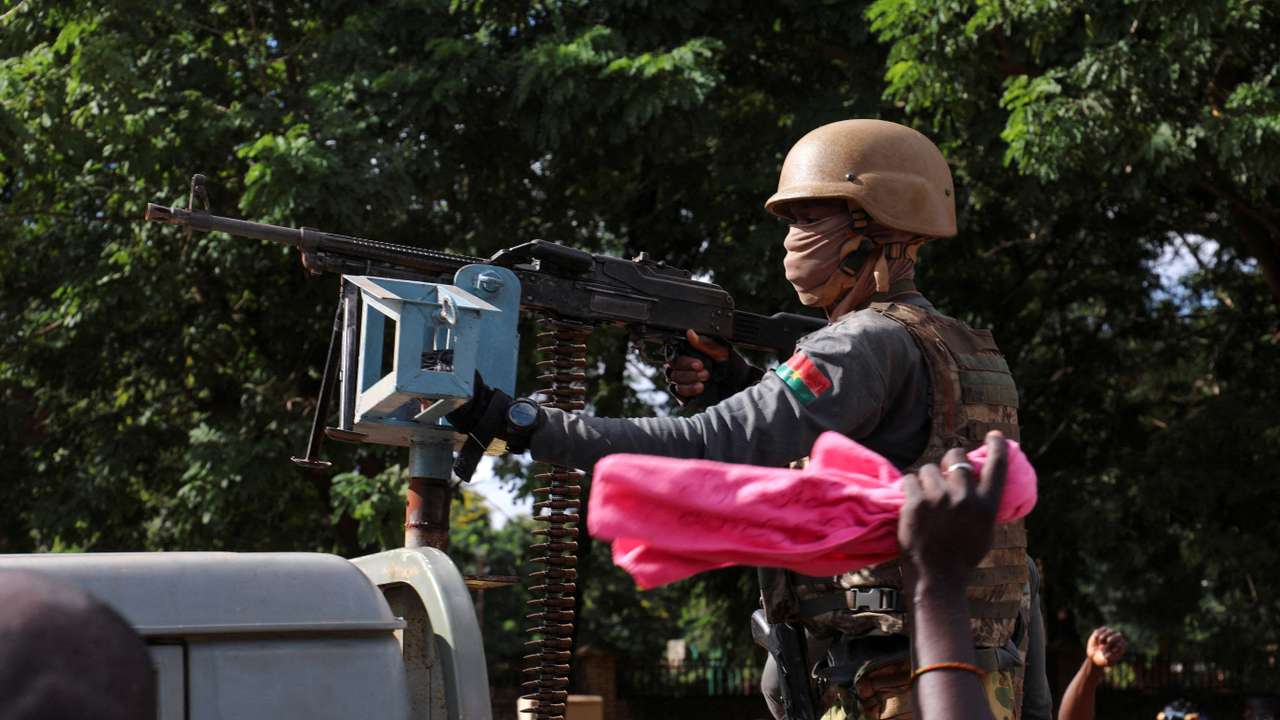 FILE PHOTO: New junta's soldiers stand guard in an armoured vehicle in Ouagadougou
