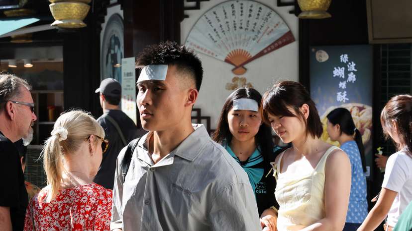 People put cooling gel sheets on their foreheads to cool themselves amid a yellow alert for heat, in Shanghai