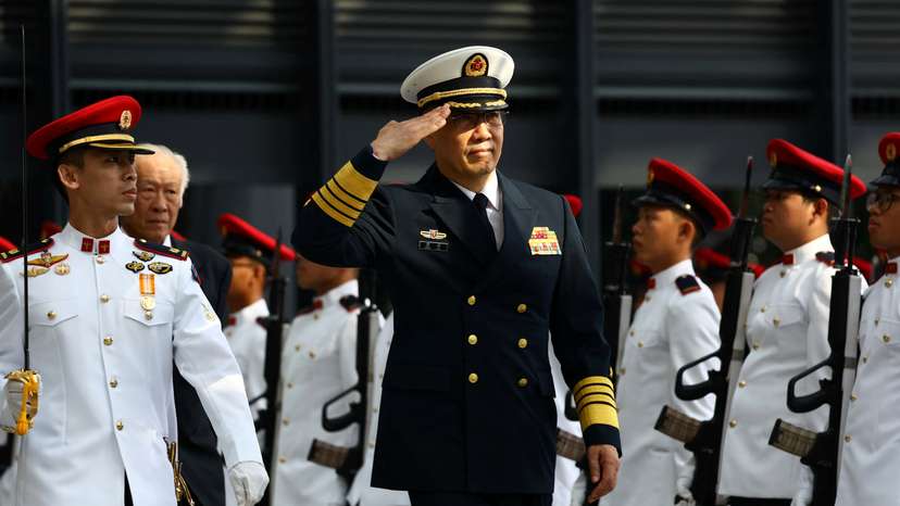 China's newly appointed Defence Minister Dong Jun inspects honour guards in Singapore