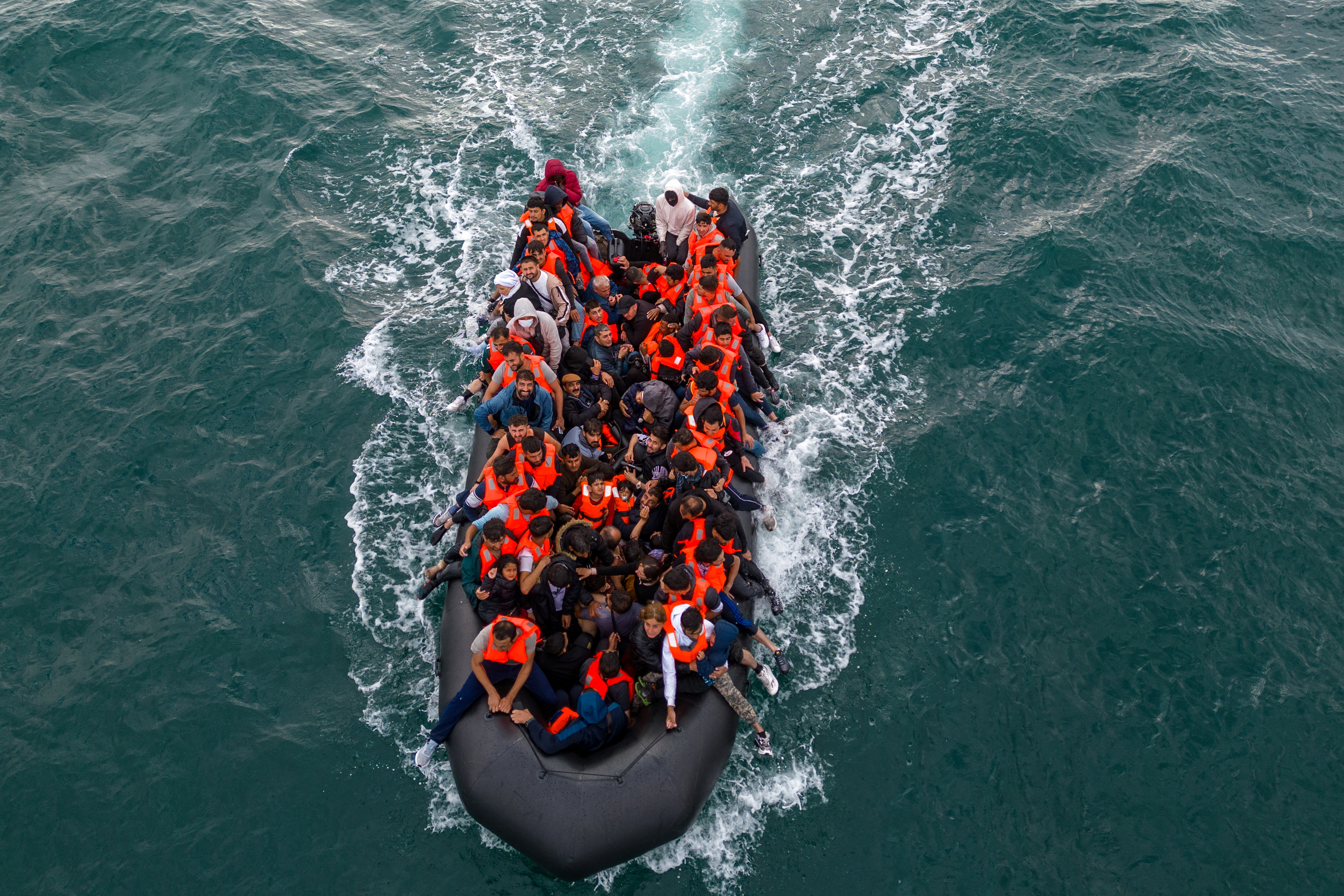 Migrants cross the English Channel in small boats