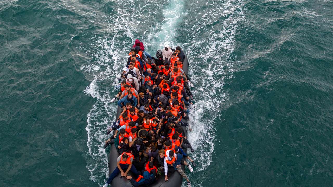 Migrants cross the English Channel in small boats
