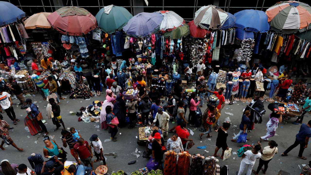 FILE PHOTO: People crowd a market place in Lagos