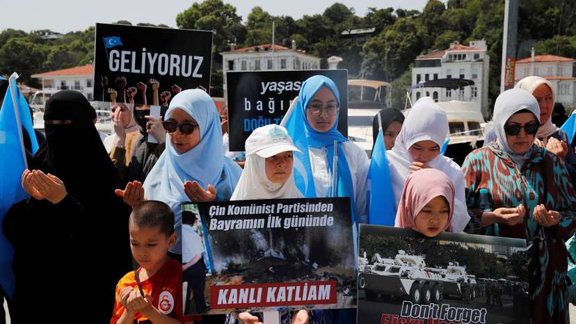 Ethnic Uyghur demonstrators take part in a protest against the visit of Chinese Foreign Minister Wang Yi to the Turkish capital in Istanbul