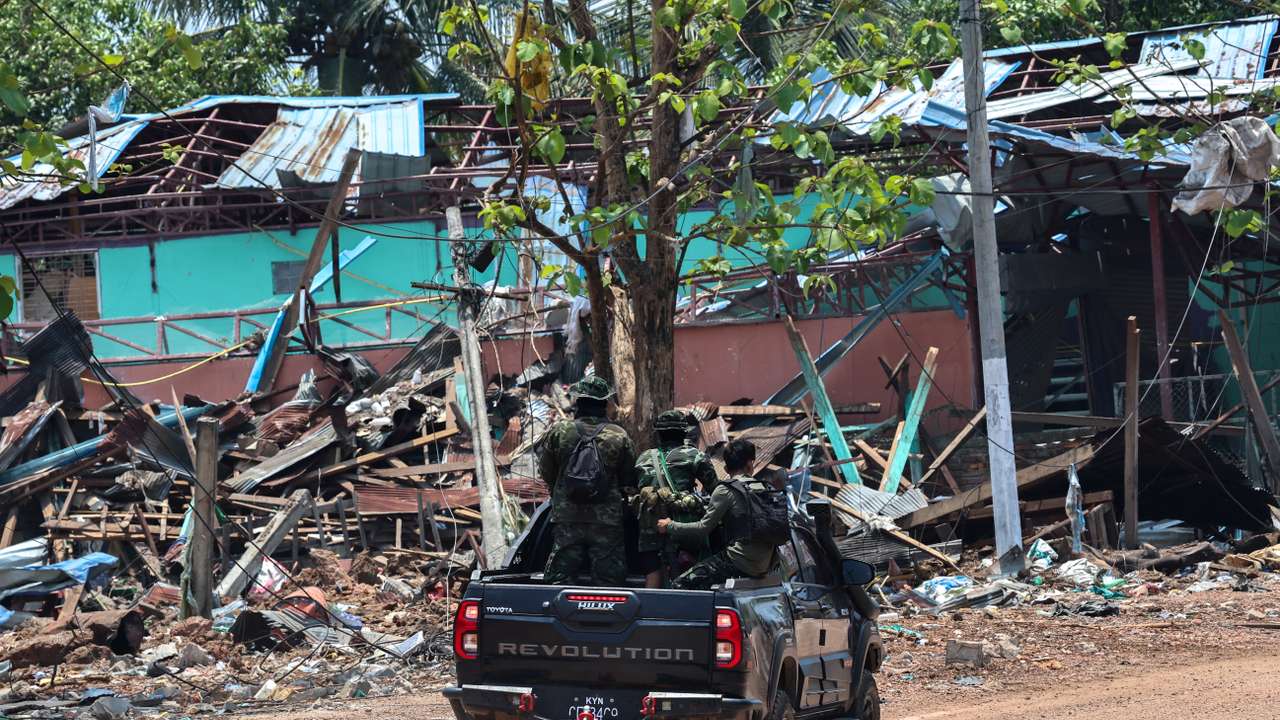 Soldiers from the Karen National Liberation Army (KNLA) patrol , next to an area destroyed by Myanmar's airstrike in Myawaddy, the Thailand-Myanmar border town under the control of a coalition of rebel forces led by the Karen National Union