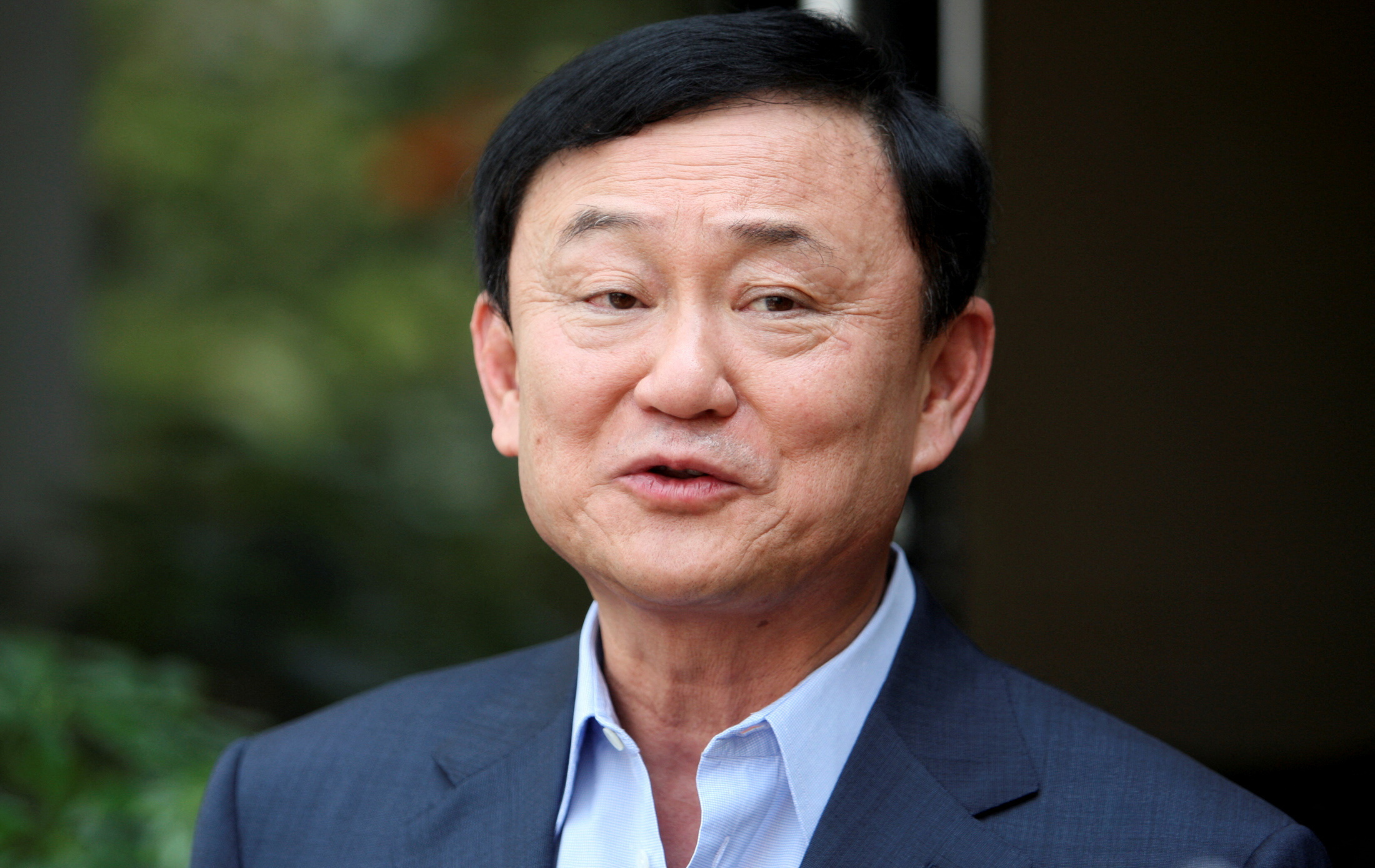 FILE PHOTO: Thailand's former premier Thaksin Shinawatra speaks to journalists outside his home in Dubai